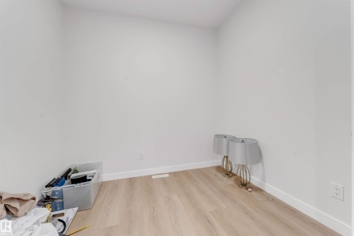 Room featuring light wood-finish flooring, white walls, and white baseboards - 7007 169 Avenue Nw, Edmonton, AB - Indoor Photo Showing Other Room