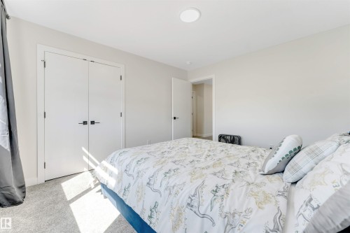 Carpeted interior with light gray walls, white trim, and a white ceiling with a recessed light fixture - 7007 169 Avenue Nw, Edmonton, AB - Indoor Photo Showing Bedroom