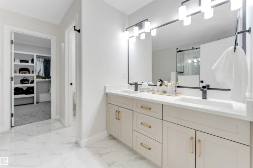 Vanity featuring dual sinks, matte black faucets, and quartz countertops - 7007 169 Avenue Nw, Edmonton, AB - Indoor Photo Showing Bathroom