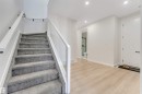 Carpeted staircase with glass panel railing and track lighting - 7007 169 Avenue Nw, Edmonton, AB  - Indoor Photo Showing Other Room 