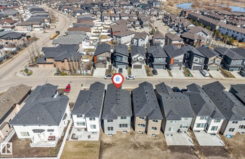 Contemporary residential property featuring a dark shingle roof and light-toned siding - 7007 169 Avenue Nw, Edmonton, AB - Outdoor With View