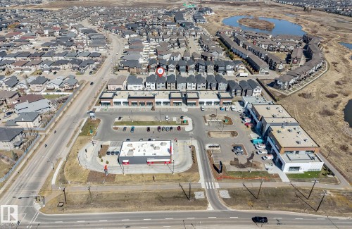 Aerial perspective showcasing a residential and commercial development - 7007 169 Avenue Nw, Edmonton, AB - Outdoor With View