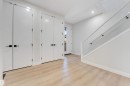 Entryway featuring light wood-finish flooring, white walls, and a modern staircase with glass railing - 7007 169 Avenue Nw, Edmonton, AB  - Indoor Photo Showing Other Room 