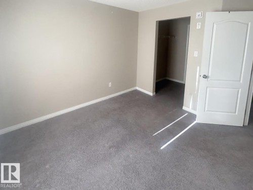 Carpeted room with neutral wall paint and white trim - 6120 7331 South Terwillegar Drive Nw, Edmonton, AB - Indoor Photo Showing Other Room