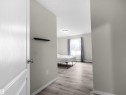 Spacious room featuring wood-finish flooring, a large window with natural light, neutral wall colors, and white trim - 7123 7327 South Terwillegar Drive, Edmonton, AB  - Indoor Photo Showing Other Room 