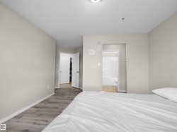 Neutral-toned interior featuring wood-finish flooring and white baseboards - 