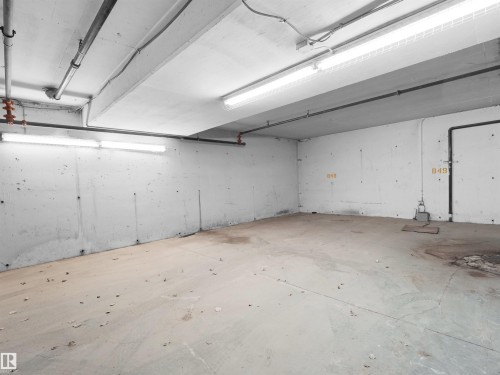 Concrete flooring with exposed ceiling utilities and fluorescent lighting - 7123 7327 South Terwillegar Drive, Edmonton, AB - Indoor Photo Showing Garage