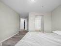 Spacious room featuring light gray walls, wood-finish flooring, and white trim - 7123 7327 South Terwillegar Drive, Edmonton, AB  - Indoor Photo Showing Bedroom 