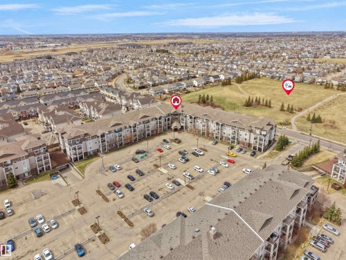 Multi-story residential buildings with balconies and surface parking - 7123 7327 South Terwillegar Drive, Edmonton, AB - Outdoor With View