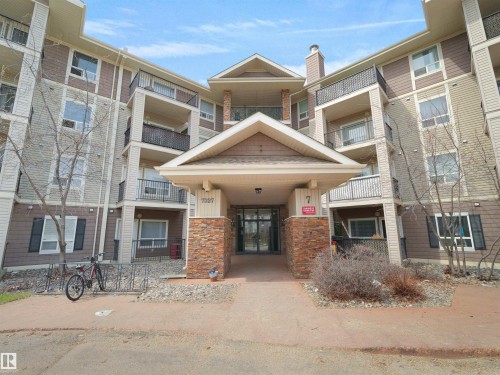 Multi-story building exterior featuring a stone and siding facade - 7123 7327 South Terwillegar Drive, Edmonton, AB - Outdoor With Facade