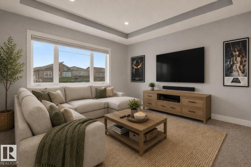 Sunlit living area featuring a large picture window, recessed lighting, and a tray ceiling. Virtually Staged. - 635 42 Street, Edmonton, AB - Indoor Photo Showing Living Room