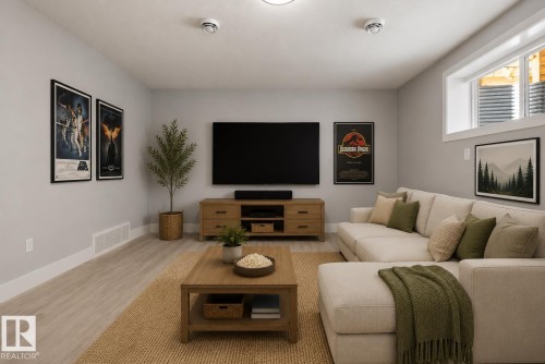 Spacious entertainment room featuring light-toned flooring, a window providing natural light, and recessed ceiling lighting. Virtually Staged. - 635 42 Street, Edmonton, AB - Indoor Photo Showing Living Room