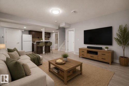 Open-concept living area featuring light wood-finish flooring, recessed lighting, and a neutral color palette. Virtually Staged. - 635 42 Street, Edmonton, AB - Indoor Photo Showing Living Room