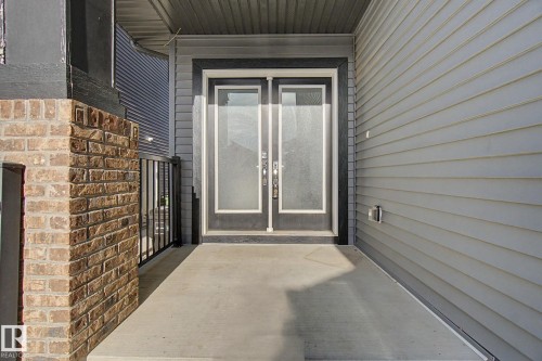 Inviting front entry featuring double doors with frosted glass panels - 635 42 Street, Edmonton, AB - Outdoor With Exterior