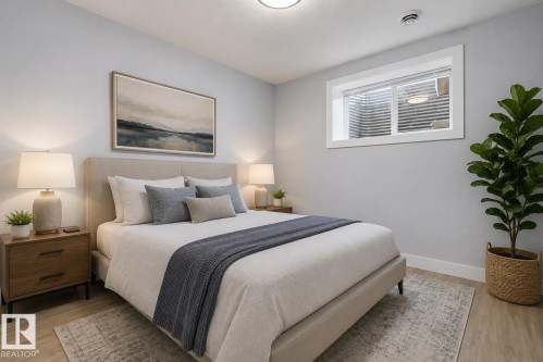 Bedroom featuring a window with white trim, wood-finish flooring, light grey painted walls, and a ceiling-mounted light fixture. Virtually Staged. - 635 42 Street, Edmonton, AB - Indoor Photo Showing Bedroom