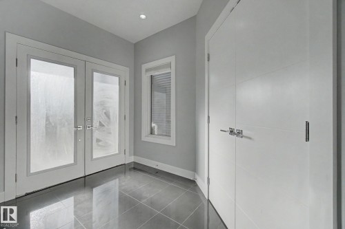 Entryway featuring reflective tile flooring, recessed lighting, and a window with blinds - 635 42 Street, Edmonton, AB - Indoor Photo Showing Other Room