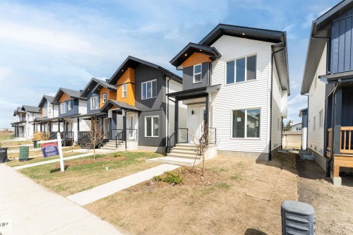 Modern multi-level exterior with contrasting white and dark siding - 12447 47 Street, Edmonton, AB - Outdoor With Facade