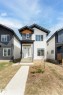 Modern architectural facade featuring white horizontal siding and dark vertical siding accents - 12447 47 Street, Edmonton, AB  - Outdoor 