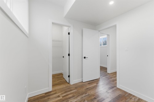 Interiors featuring wood-finish flooring, white walls, and recessed lighting - 12447 47 Street, Edmonton, AB - Indoor Photo Showing Other Room