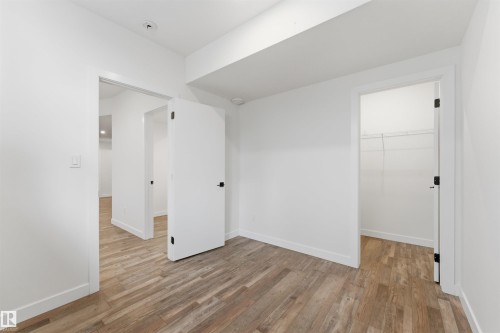 Room featuring wood-finish flooring, white walls, and a recessed light fixture - 12447 47 Street, Edmonton, AB - Indoor Photo Showing Other Room