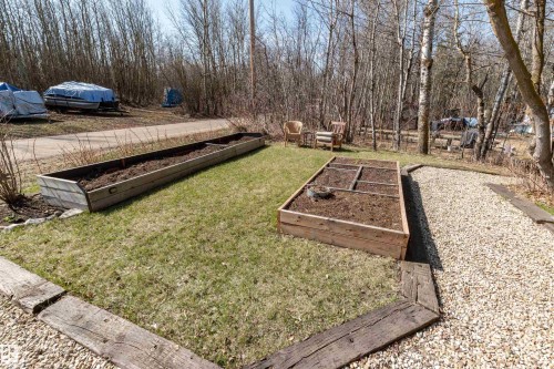 Sunny front area with raised beds is perfect for gardening.  There is a well nearby (no pump) useful for watering. - 197 51268 Range Road 204, Rural Strathcona County, AB 
