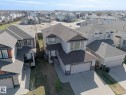 Two-story property featuring a front-facing attached garage, stone accents on the lower facade, and light-colored siding - 151 Caledonia Drive, Leduc, AB  - Outdoor 