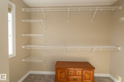 Custom closet system featuring multiple wire shelves and hanging rods - 151 Caledonia Drive, Leduc, AB - Indoor With Storage