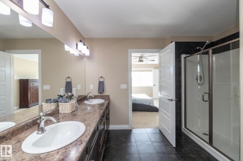 Double vanity with integrated sinks and chrome fixtures - 151 Caledonia Drive, Leduc, AB - Indoor Photo Showing Bathroom