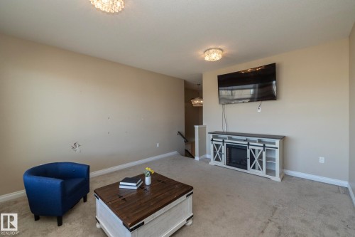 Recessed lighting illuminates the carpeted flooring and neutral wall tones - 151 Caledonia Drive, Leduc, AB - Indoor