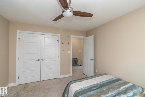 Neutral tone walls complementing the textured carpet flooring - 151 Caledonia Drive, Leduc, AB - Indoor Photo Showing Bedroom