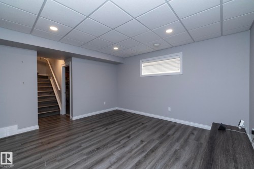 Spacious interior room featuring wood-finish flooring, light gray walls, and recessed ceiling lighting - 151 Caledonia Drive, Leduc, AB - Indoor Photo Showing Other Room