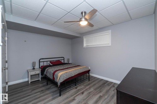 Spacious room featuring wood-finish flooring, light gray wall paint, and white baseboards - 151 Caledonia Drive, Leduc, AB - Indoor Photo Showing Bedroom