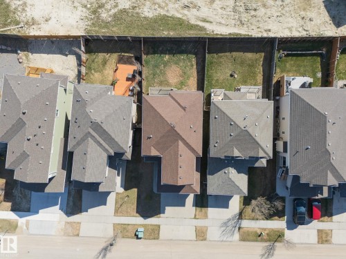 Aerial view showcasing multiple residential properties with varied rooflines and asphalt shingles - 151 Caledonia Drive, Leduc, AB - Outdoor