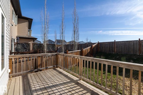 Spacious wooden deck with a slatted railing, providing outdoor living space - 151 Caledonia Drive, Leduc, AB - Outdoor With Exterior