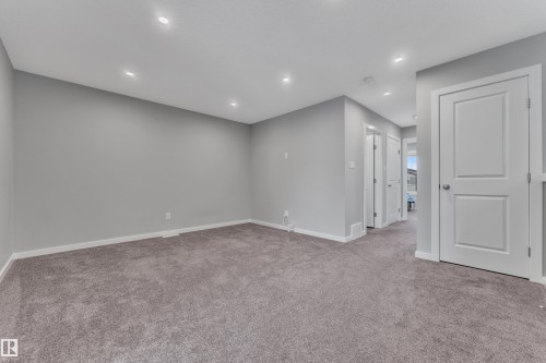 Spacious room featuring neutral grey walls and plush grey carpet flooring - 319 36 Avenue, Edmonton, AB - Indoor Photo Showing Other Room