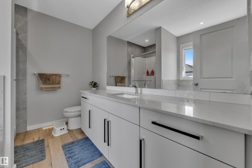 Modern vanity with dual sinks, quartz countertop, and extensive storage cabinetry - 319 36 Avenue, Edmonton, AB - Indoor Photo Showing Bathroom
