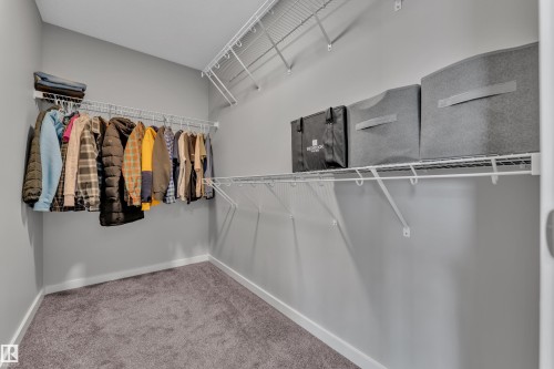 Walk-in closet featuring light gray walls, gray carpeting, and white wire shelving with integrated hanging rods - 319 36 Avenue, Edmonton, AB - Indoor With Storage