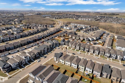 Aerial overview of a residential neighborhood featuring rows of modern homes with varying facades - 319 36 Avenue, Edmonton, AB - Outdoor With View