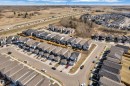 Aerial perspective of a suburban neighborhood with numerous residential properties featuring light-colored siding and dark shingled roofs - 319 36 Avenue, Edmonton, AB  - Outdoor With View 