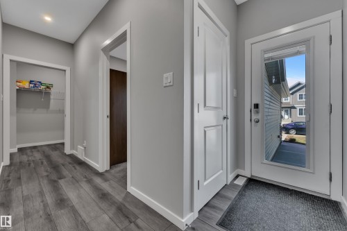 Entryway featuring wood-finish flooring, light gray wall paint, and white trim - 319 36 Avenue, Edmonton, AB - Indoor Photo Showing Other Room