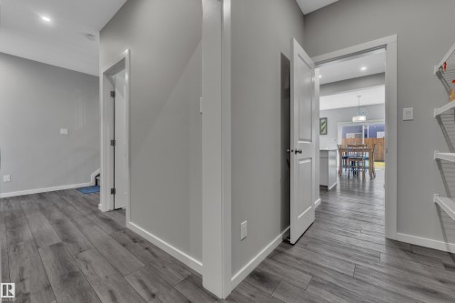 Interior hallway featuring wood-finish flooring, light gray walls, and white trim - 319 36 Avenue, Edmonton, AB - Indoor Photo Showing Other Room