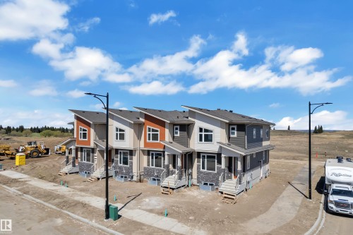 Contemporary townhome exteriors featuring varied siding materials and stone accents - 173 Graybriar Drive, Stony Plain, AB - Outdoor