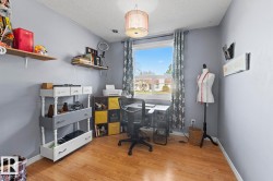 Room with light wood-finish flooring and light gray walls - 