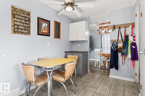 Kitchenette space featuring recessed cabinetry, dark countertop, and overhead ceiling fan - 4908 59 Street, Cold Lake, AB - Indoor Photo Showing Dining Room