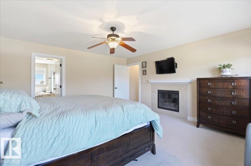 30 Ravine Drive, Devon, AB - Indoor Photo Showing Bedroom With Fireplace