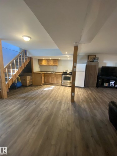 This spacious room features light-toned hardwood style flooring throughout - 5030 40 Street, Cold Lake, AB - Indoor