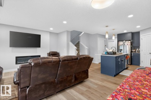 Open-concept living space with wood-finish flooring - 3214 9 Street, Edmonton, AB - Indoor