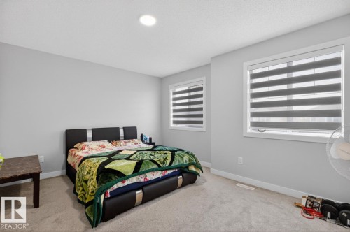 Bright room featuring two windows with horizontal blinds, neutral wall paint, and recessed ceiling lighting - 3214 9 Street, Edmonton, AB - Indoor Photo Showing Bedroom
