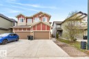 Two-story duplex featuring red siding accents and beige trim - 3214 9 Street, Edmonton, AB  - Outdoor With Facade 