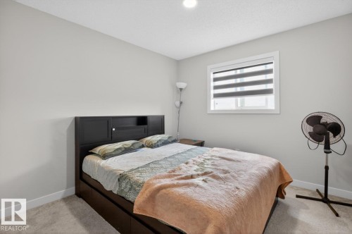 Bedroom featuring light gray walls, white trim, and a window with blinds - 3214 9 Street, Edmonton, AB - Indoor Photo Showing Bedroom